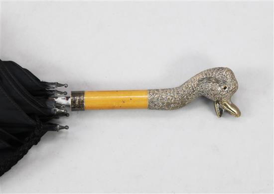 A late Victorian parasol with silver handle modelled as the head of a duck, handle overall 6in.